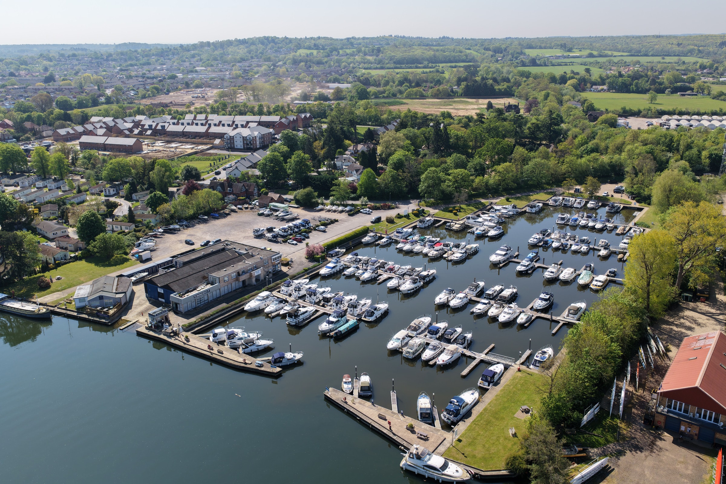 Aerial view of a riverside marina filled with boats